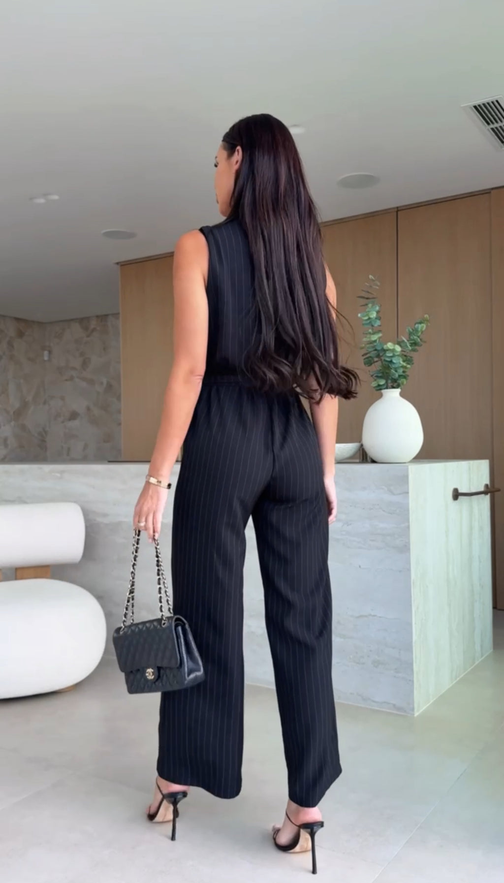 Sleeveless jumpsuit with light stripes and crisscross bodice - Black