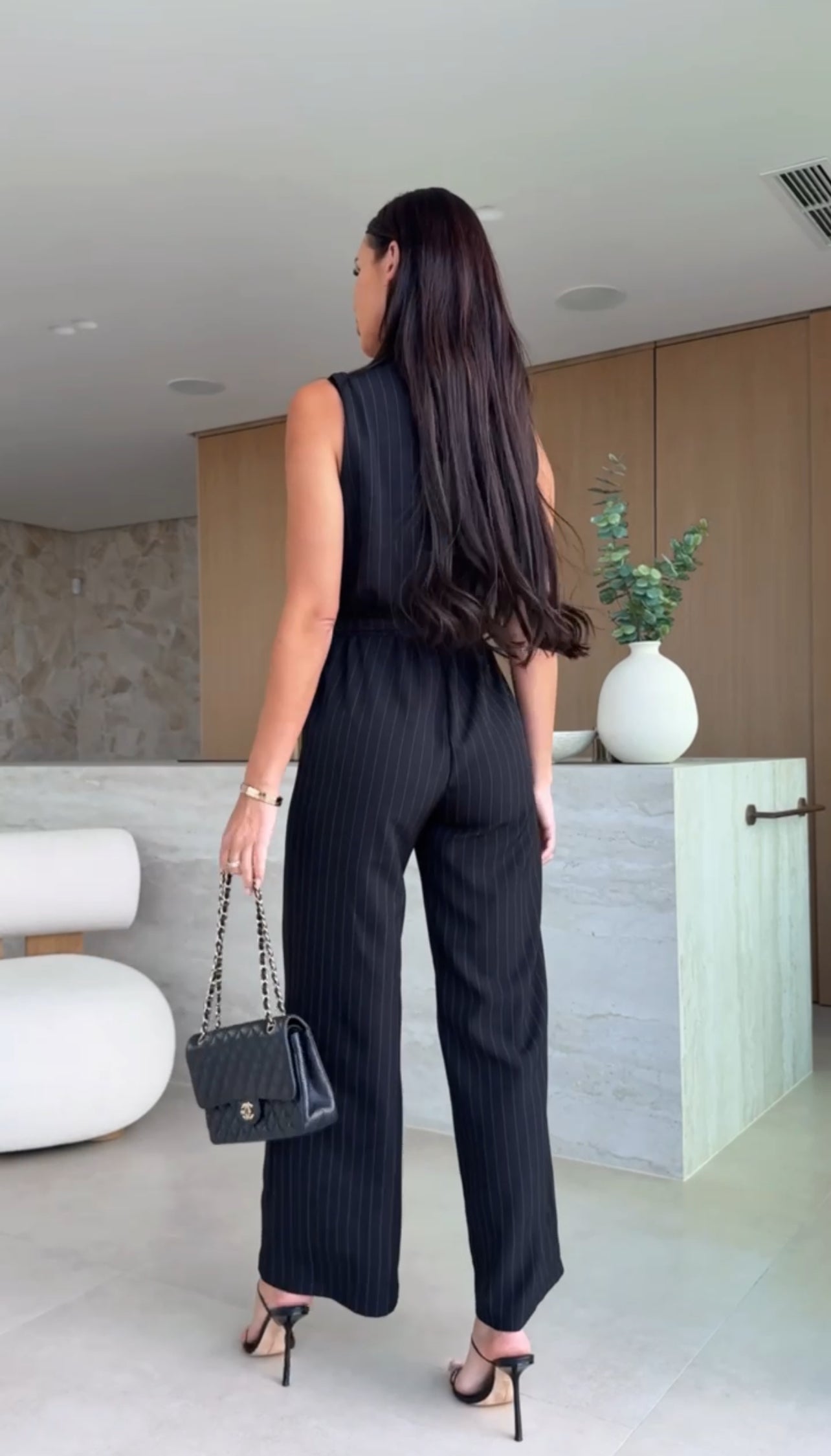 Sleeveless jumpsuit with light stripes and crisscross bodice - Black